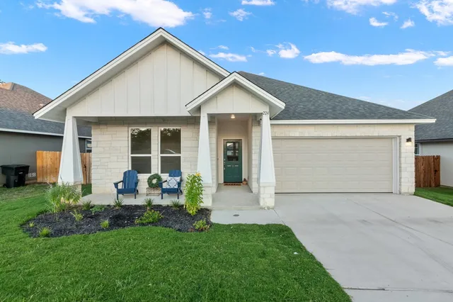a front view of house with yard and outdoor seating