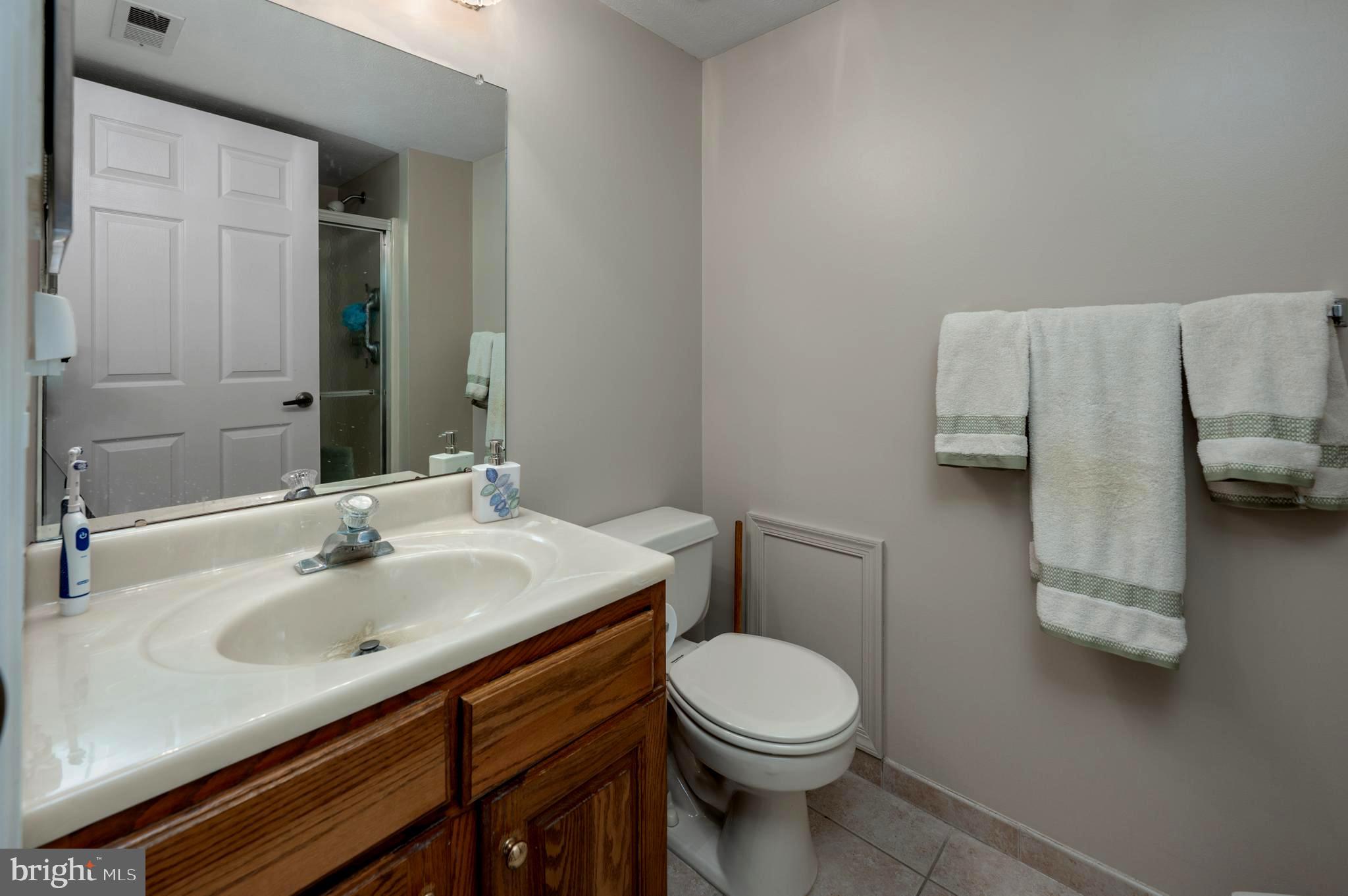 515 Hydrangea Drive Mount Laurel, NJ 08054 - Photo 19 of 36 a bathroom with a toilet sink and mirror