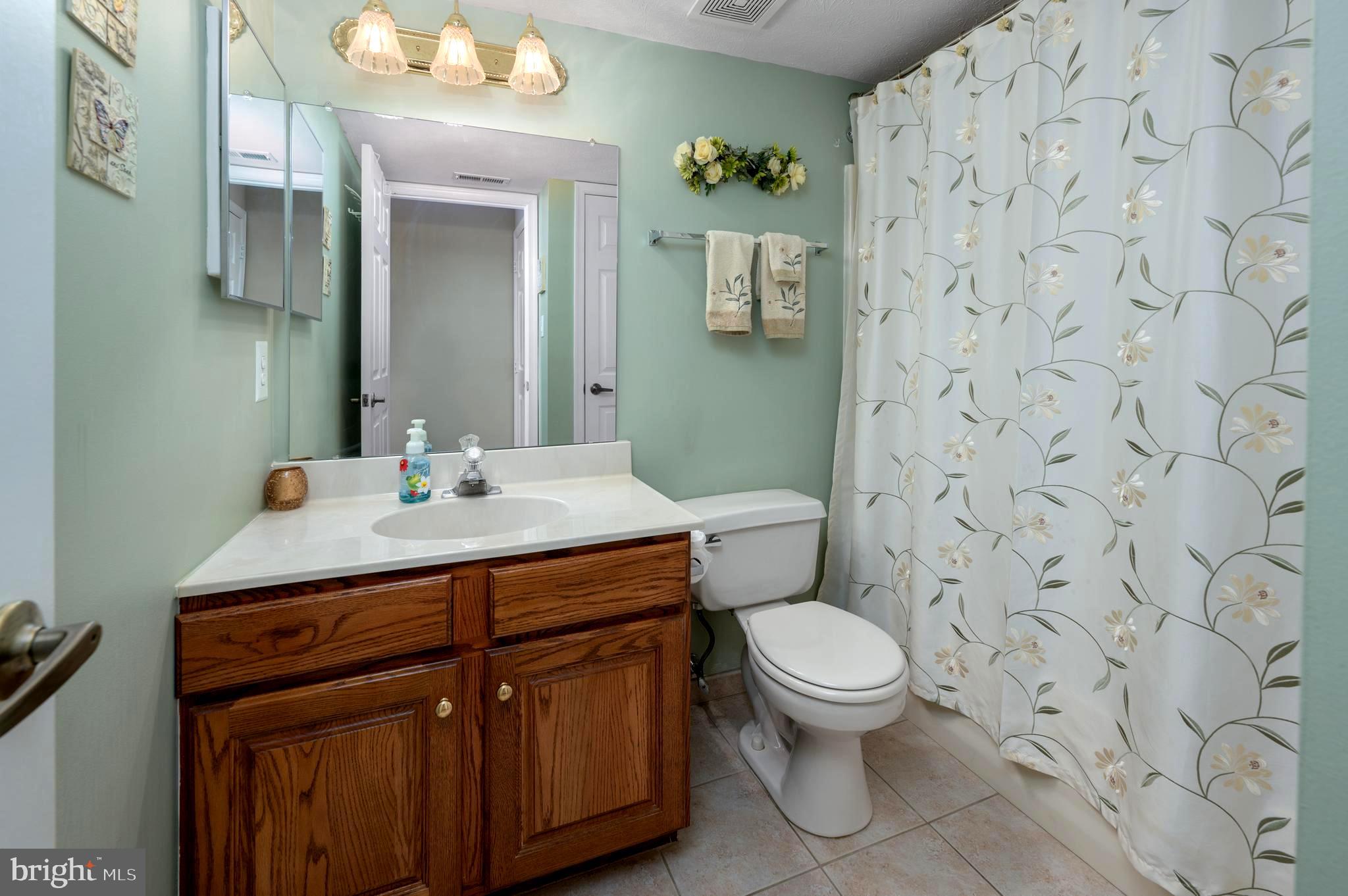 515 Hydrangea Drive Mount Laurel, NJ 08054 - Photo 21 of 36 a bathroom with a granite countertop sink a toilet and a mirror