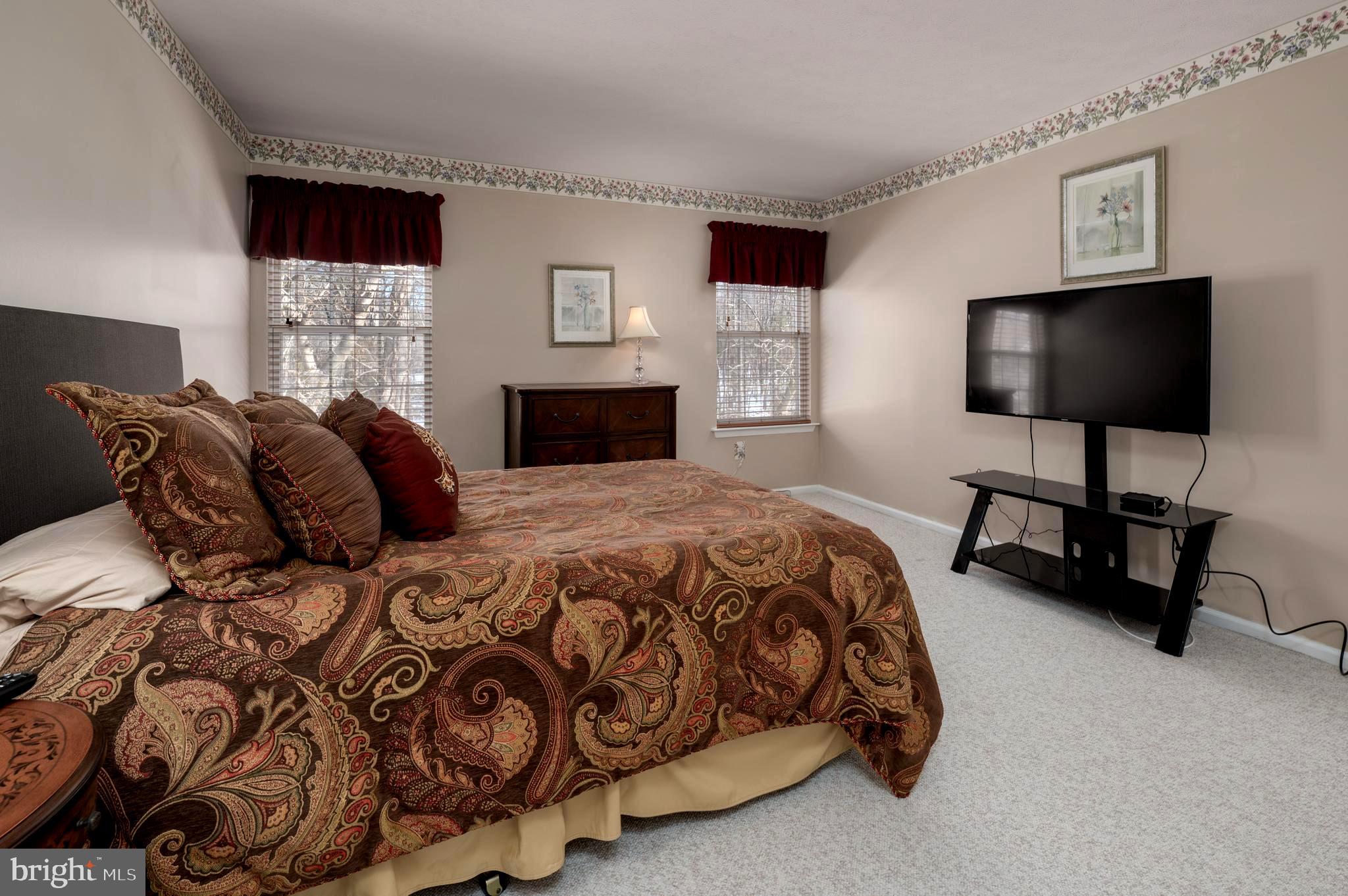515 Hydrangea Drive Mount Laurel, NJ 08054 - Photo 23 of 36 a spacious bedroom with a bed and a flat screen tv