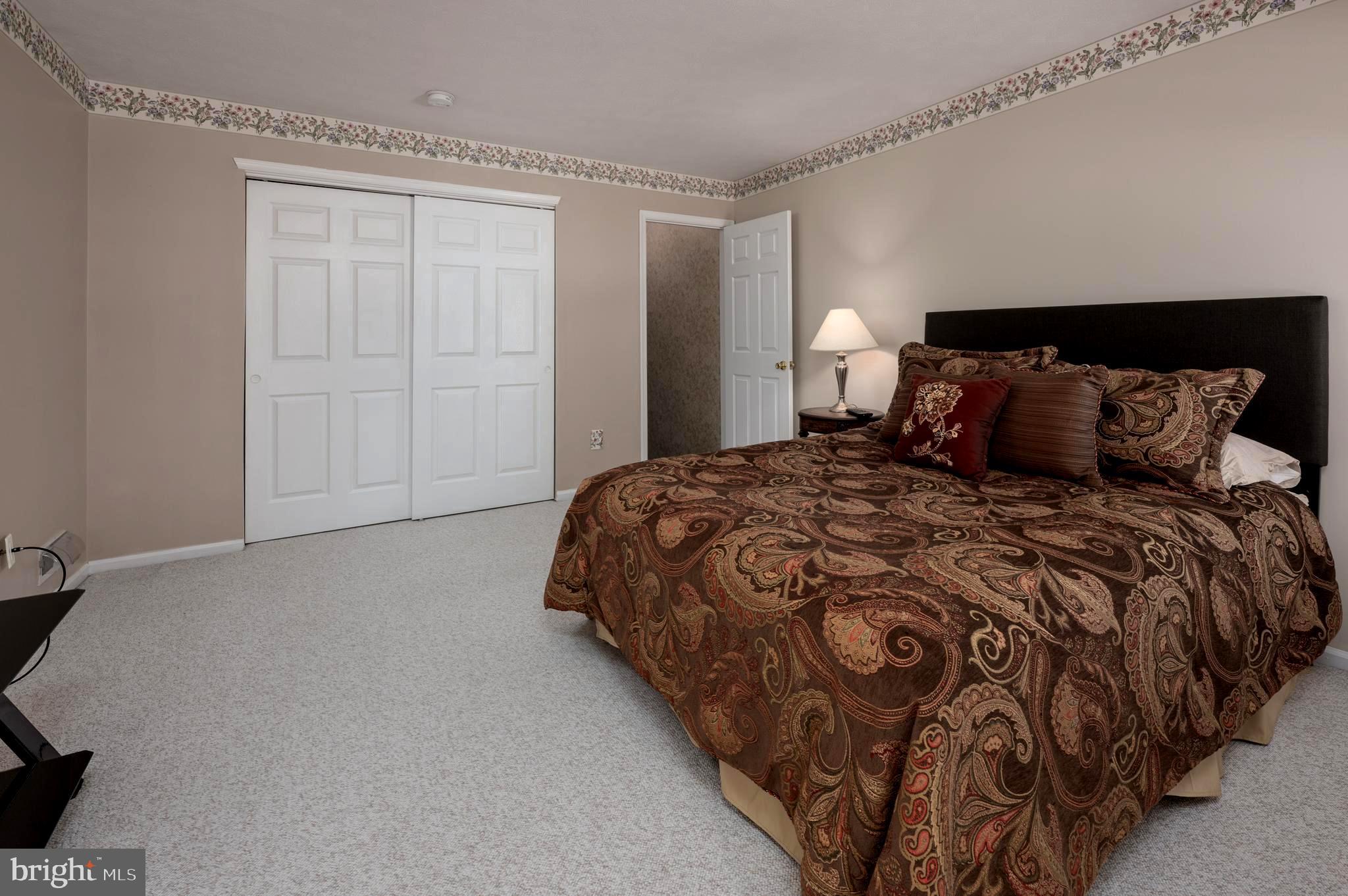 515 Hydrangea Drive Mount Laurel, NJ 08054 - Photo 24 of 36 a bedroom with a bed and a lamp