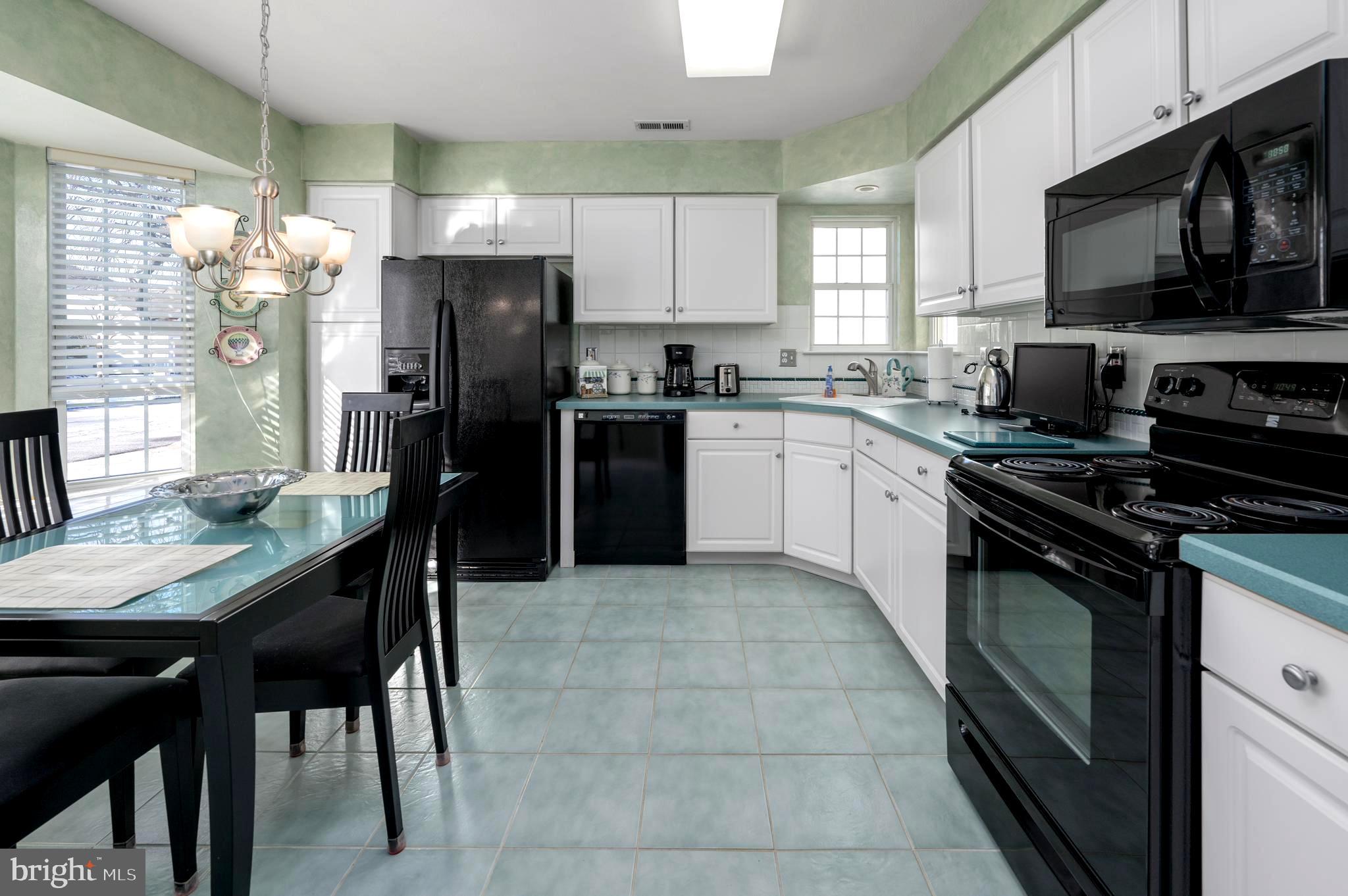 515 Hydrangea Drive Mount Laurel, NJ 08054 - Photo 4 of 36 a kitchen with stainless steel appliances granite countertop a stove refrigerator sink and cabinets