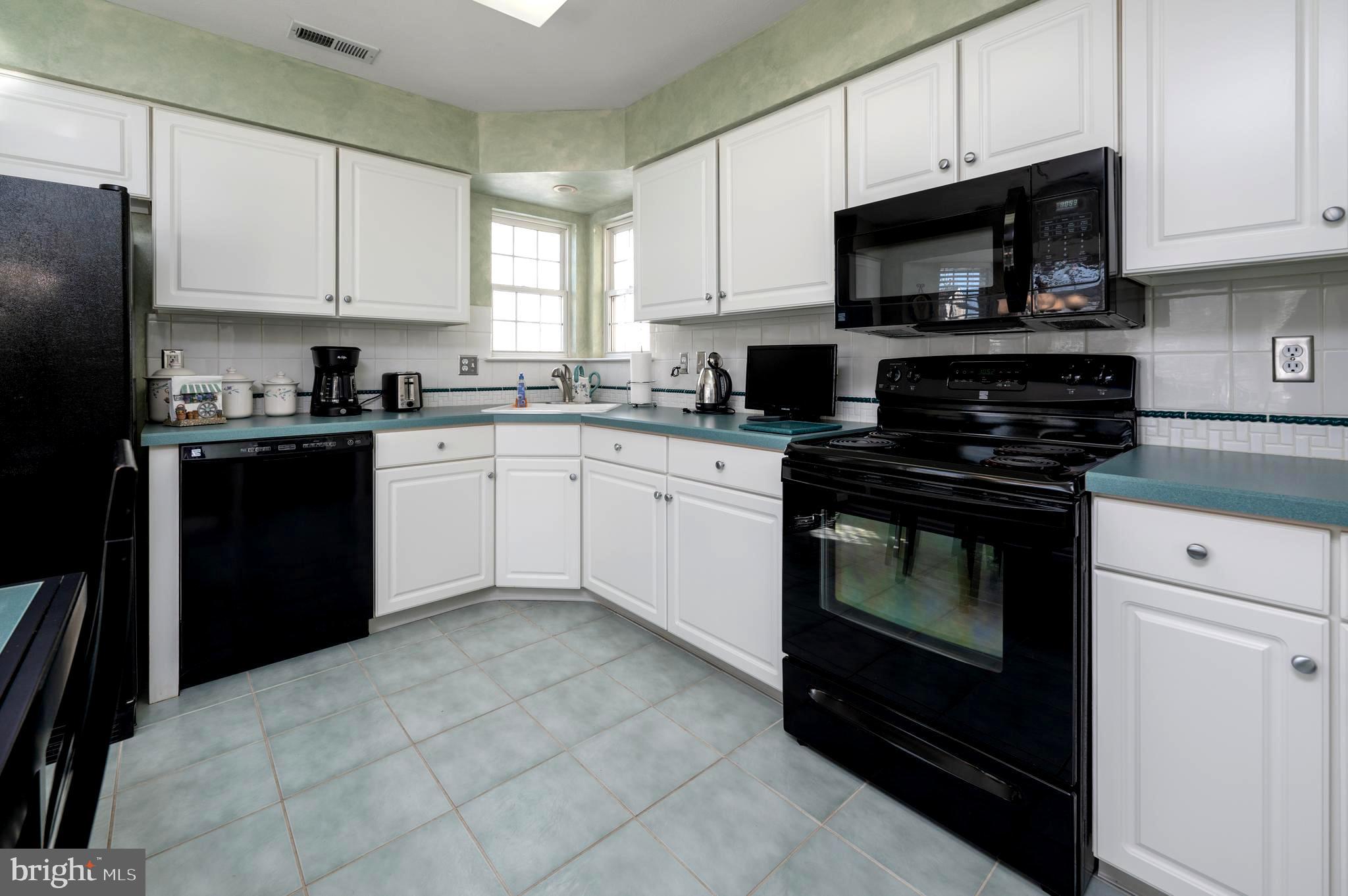 515 Hydrangea Drive Mount Laurel, NJ 08054 - Photo 6 of 36 a kitchen with cabinets stainless steel appliances and wooden cabinets