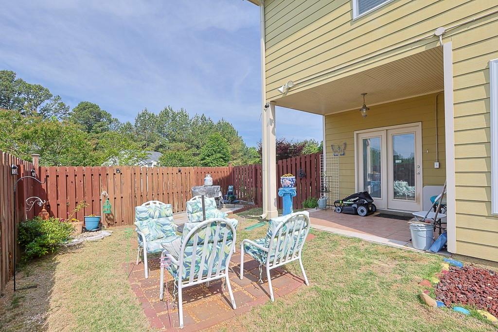 300 Hampton Place Canton, GA 30115 - Photo 71 of 82 a view of a patio with table and chairs and potted plants