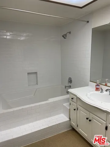 a bathroom with a sink vanity and mirror