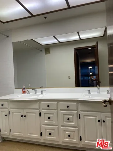 a bathroom with a shower and a sink