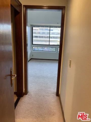 a view of an empty room with a large window