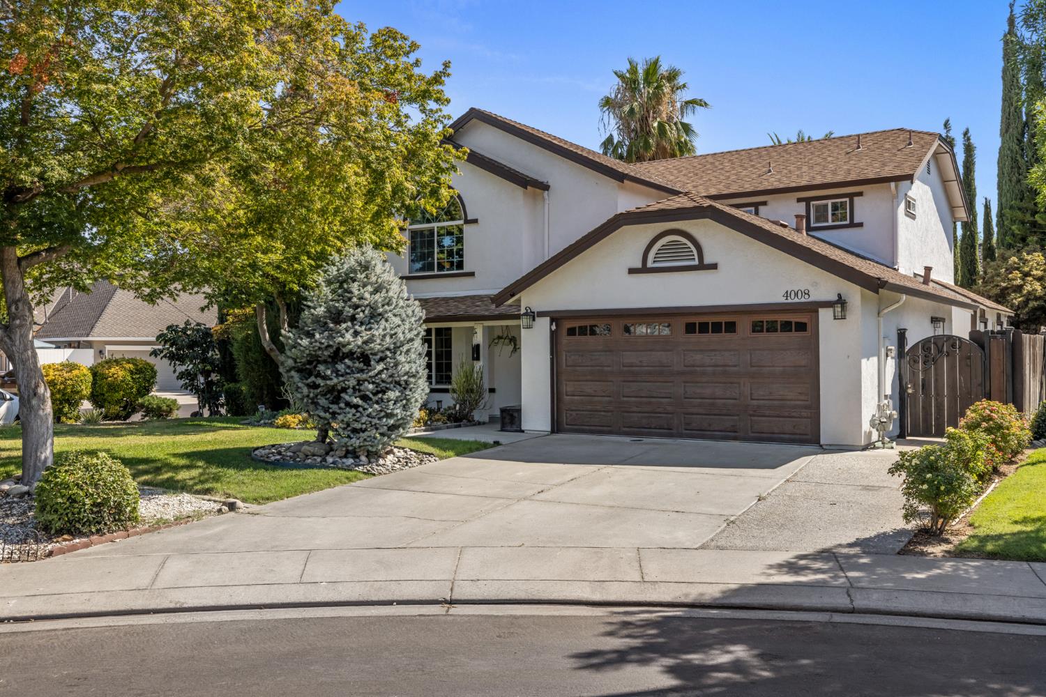 4008 Cromwell Circle Modesto, CA 95356 - Photo 1 of 1 a front view of a house with a yard and garage