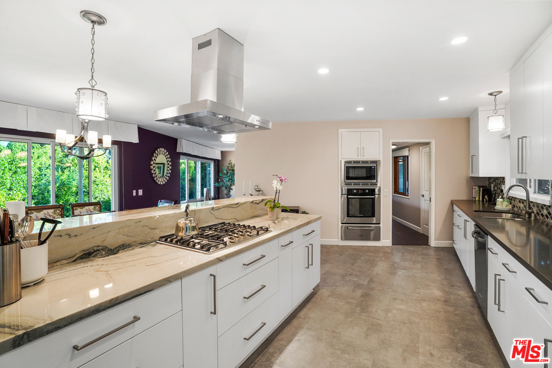 910 Hillcroft Road Glendale, CA 91207 - Photo 13 of 37 a kitchen with stainless steel appliances granite countertop a stove and a sink