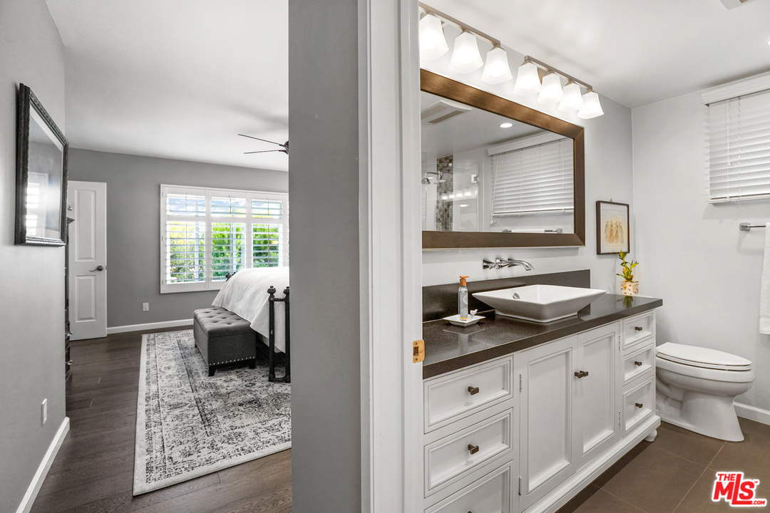 910 Hillcroft Road Glendale, CA 91207 - Photo 18 of 37 a en suite bathroom with a granite countertop sink and a mirror