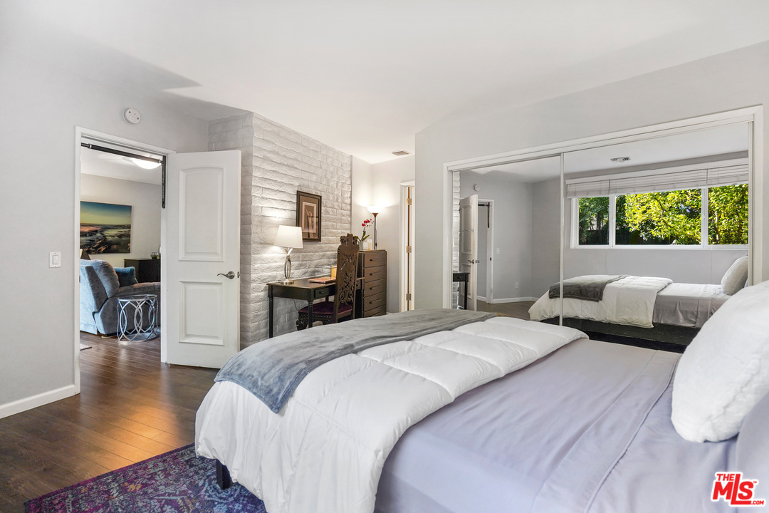 910 Hillcroft Road Glendale, CA 91207 - Photo 26 of 37 a large bedroom with a bed and wooden floor