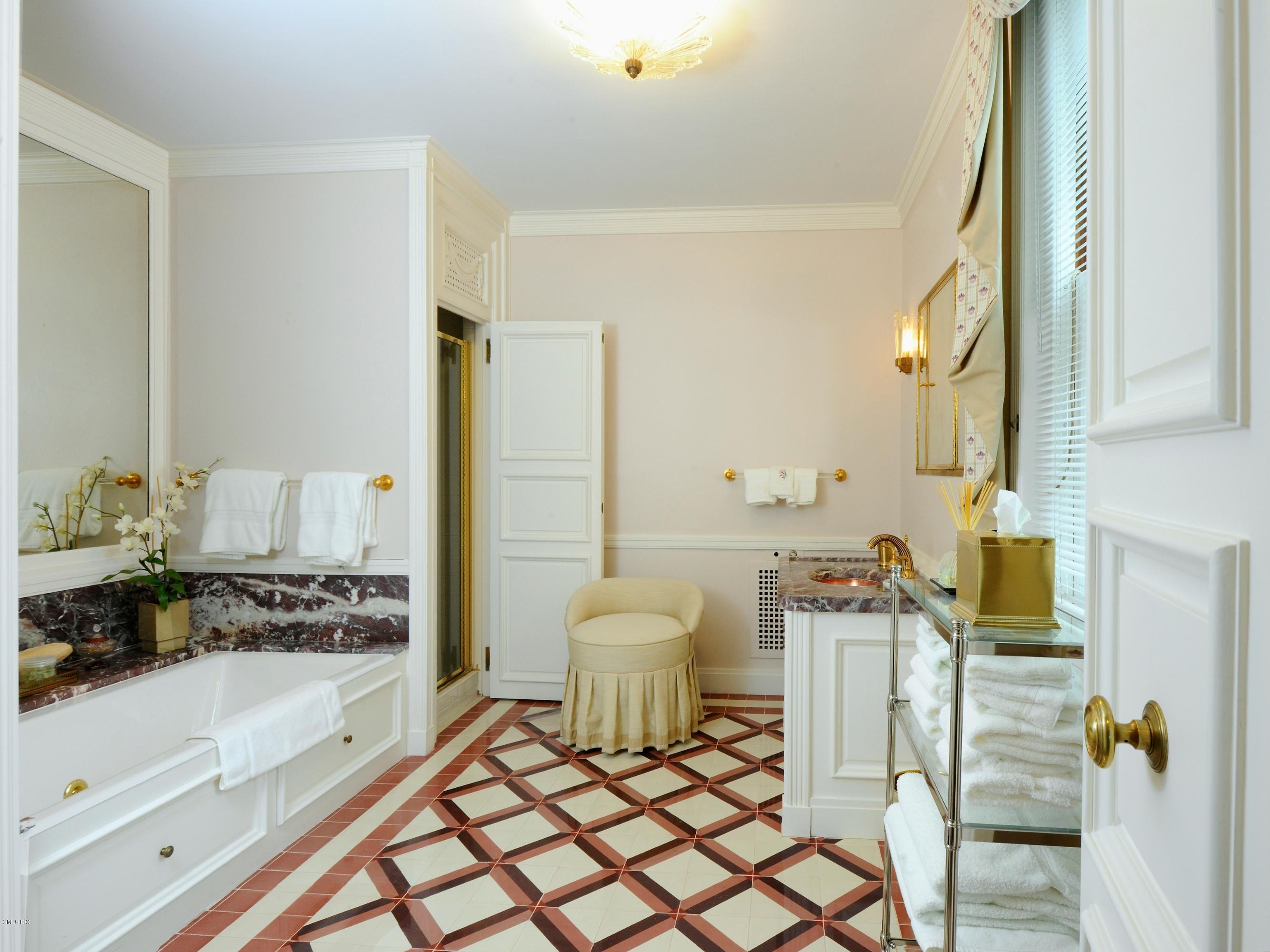 141 Taconic Road Greenwich, CT 06831 - Photo 15 of 30 a bathroom with a bathtub sink mirror and toilet