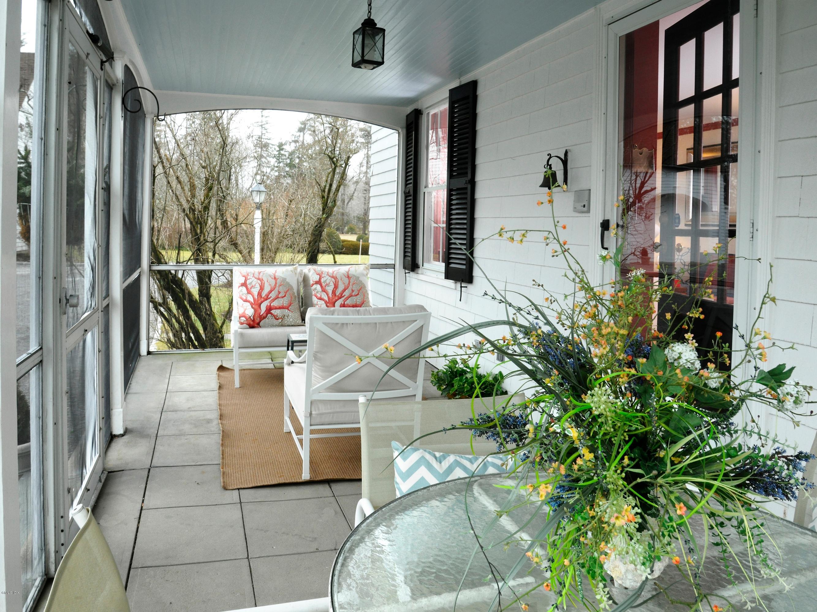 141 Taconic Road Greenwich, CT 06831 - Photo 22 of 30 a living room filled with furniture and a floor to ceiling window