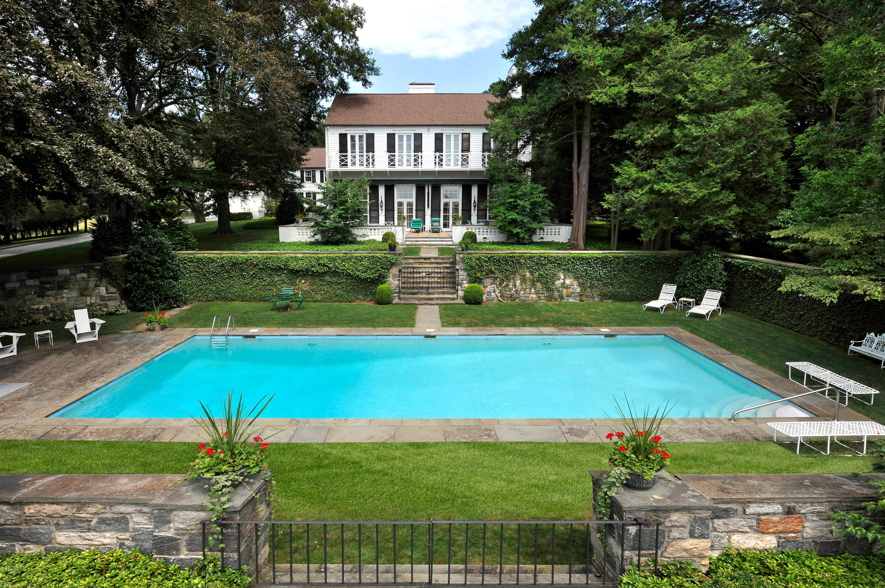 141 Taconic Road Greenwich, CT 06831 - Photo 23 of 30 a view of a house with a swimming pool
