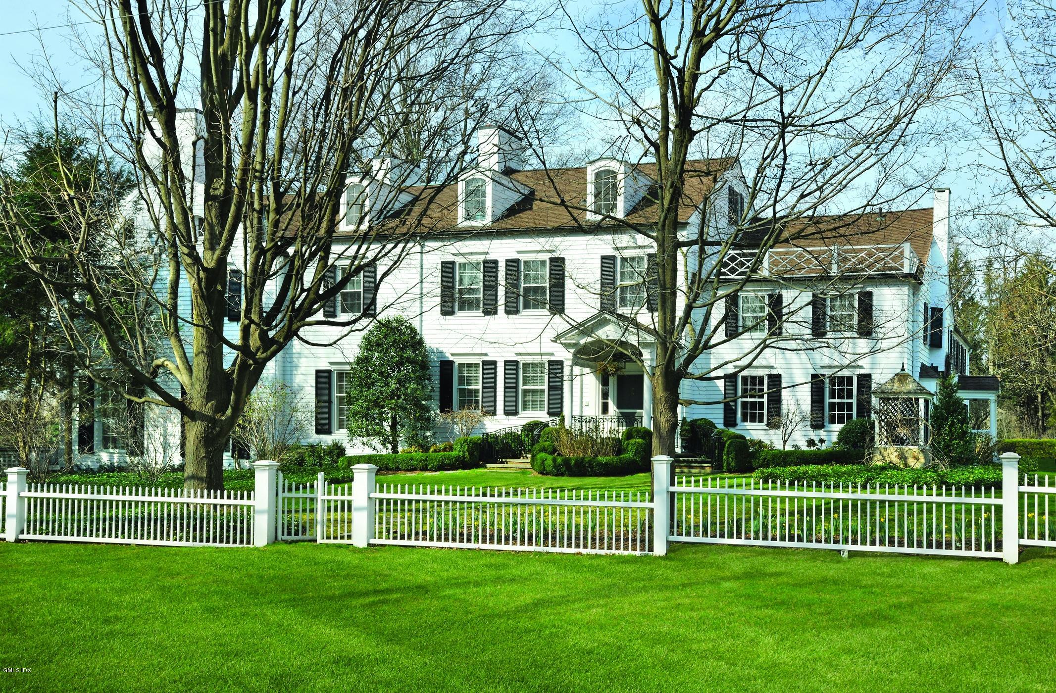 141 Taconic Road Greenwich, CT 06831 - Photo 24 of 30 a front view of a house with a garden