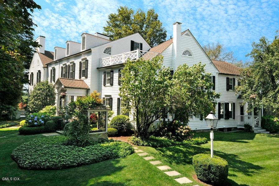 141 Taconic Road Greenwich, CT 06831 - Photo 25 of 30 a front view of a house with a yard