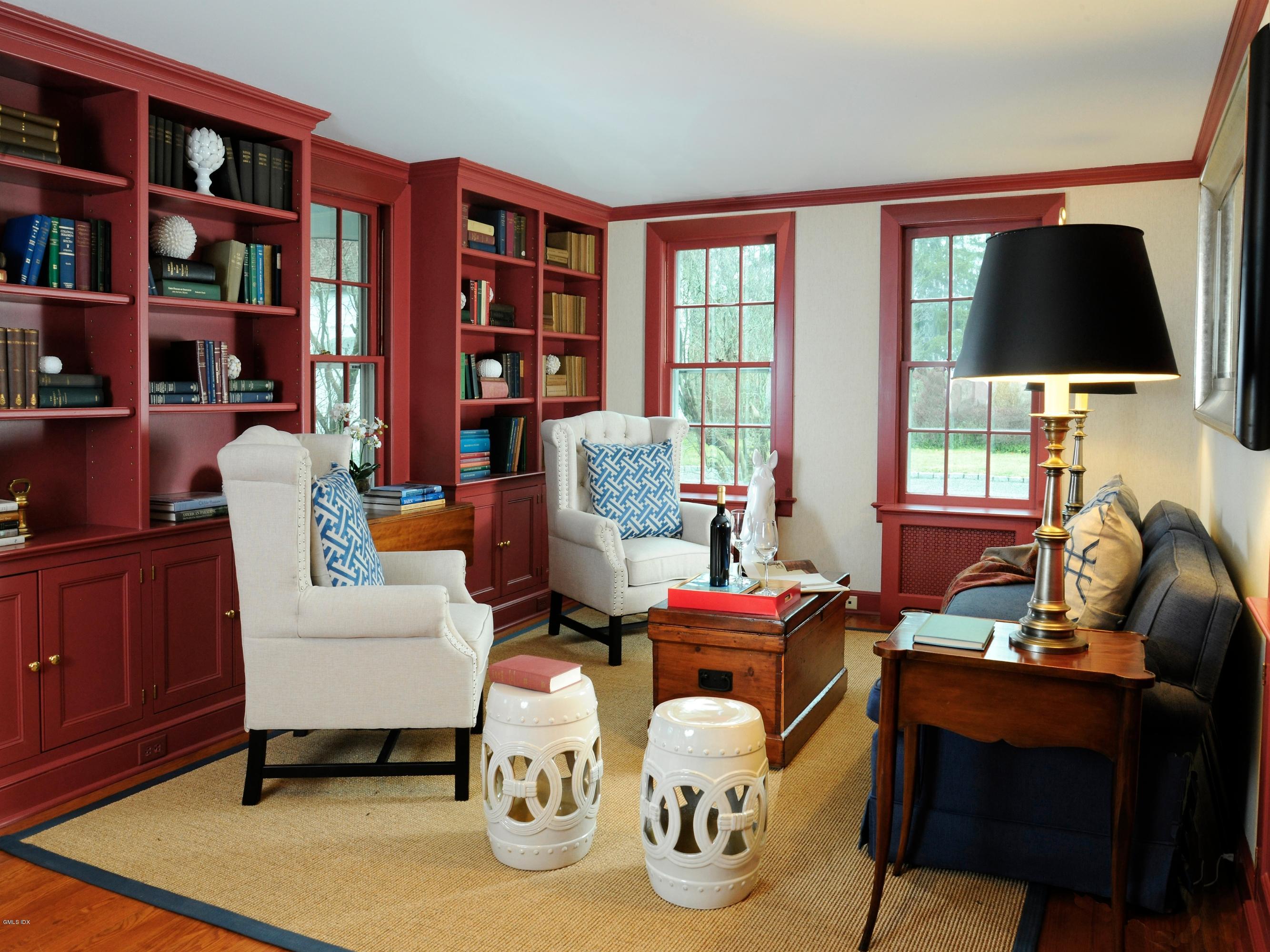 141 Taconic Road Greenwich, CT 06831 - Photo 10 of 30 a living room with furniture a flat screen tv and a bookshelf