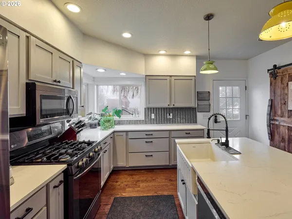 a kitchen with refrigerator and chairs