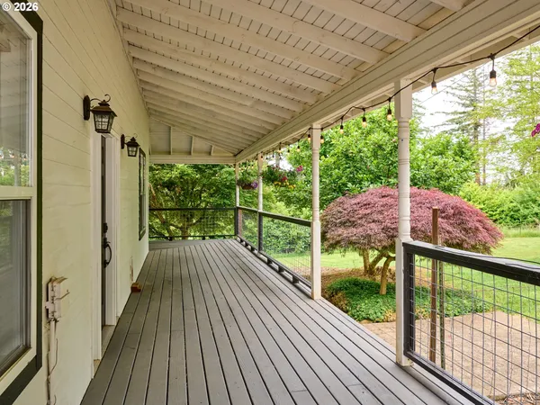 a view of deck with table and chairs a barbeque with wooden floor and fence