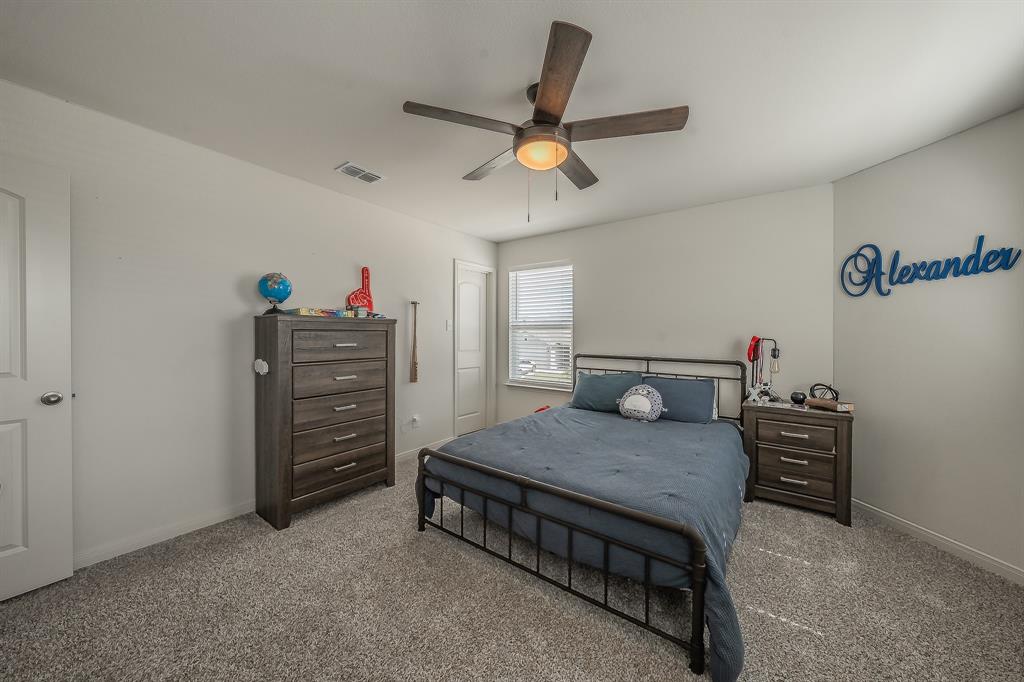 8125 White Sulphur Road Ponder, TX 76259 - Photo 27 of 38 Carpeted room featuring a ceiling fan, window with blinds, and white trim