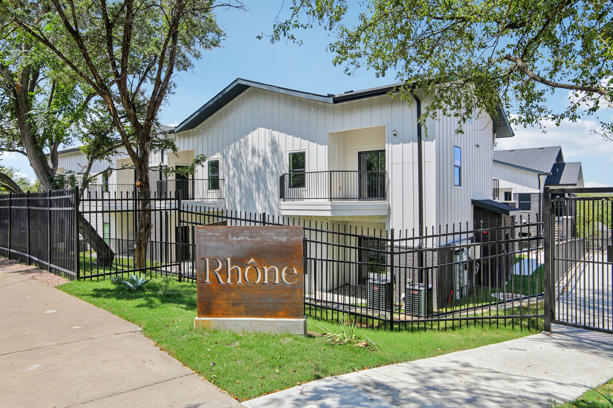 Community sign featuring a balcony