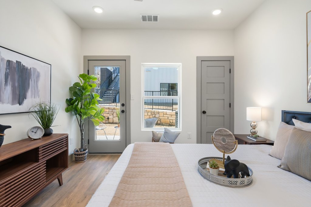 2450 Wickersham Lane, Unit 1916 Austin, TX 78741 - Photo 16 of 37 a bedroom with bed and a couch