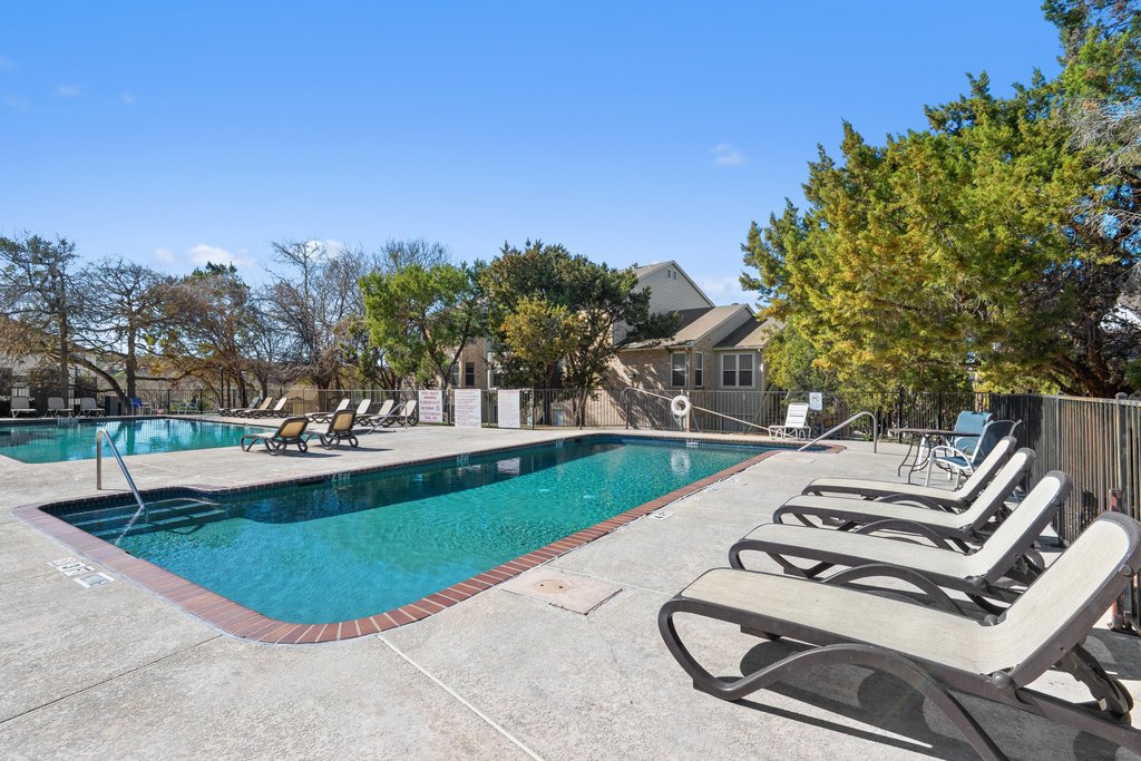 2450 Wickersham Lane, Unit 1916 Austin, TX 78741 - Photo 24 of 37 a view of a swimming pool with outdoor seating and plants