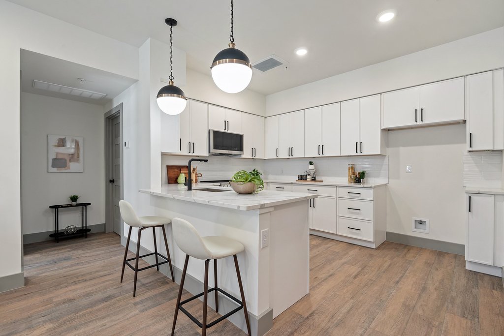 2450 Wickersham Lane, Unit 1916 Austin, TX 78741 - Photo 3 of 37 a kitchen with white cabinets stainless steel appliances and wooden floor