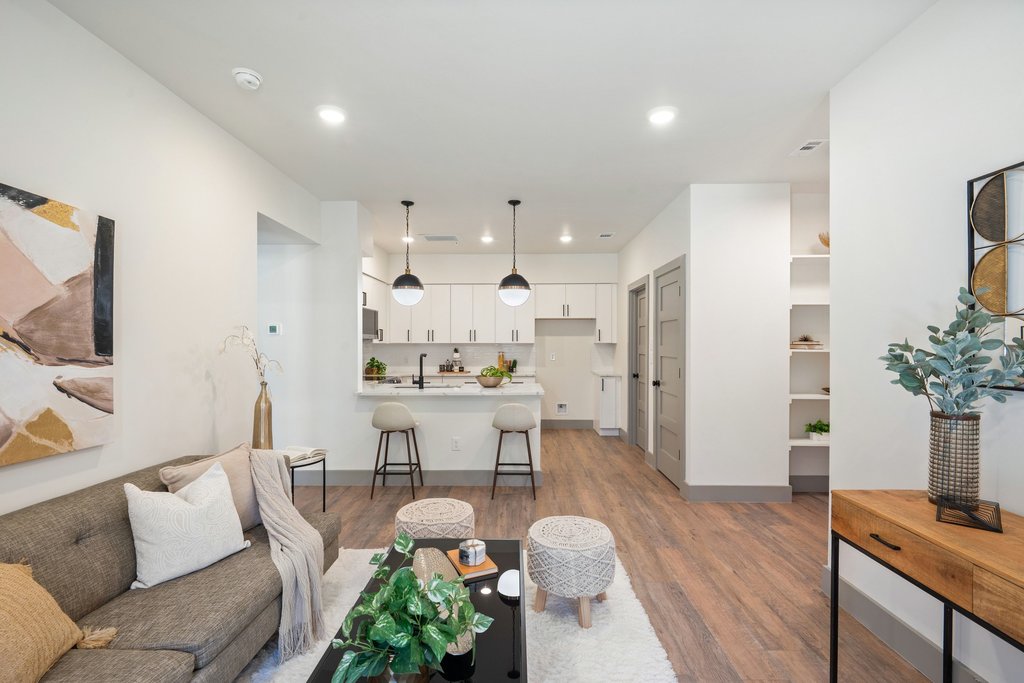 2450 Wickersham Lane, Unit 1916 Austin, TX 78741 - Photo 6 of 37 a living room with furniture kitchen view and a wooden floor