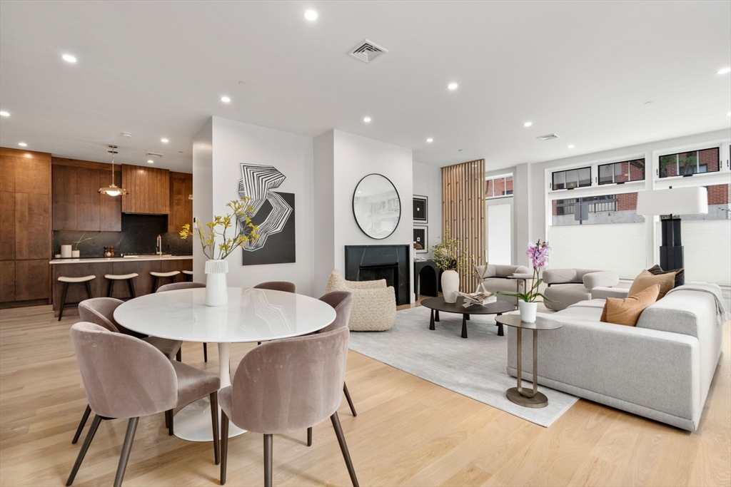 67 Church Street, Unit 1 Boston, MA 02116 - Photo 1 of 15 a living room with fireplace furniture and a wooden floor