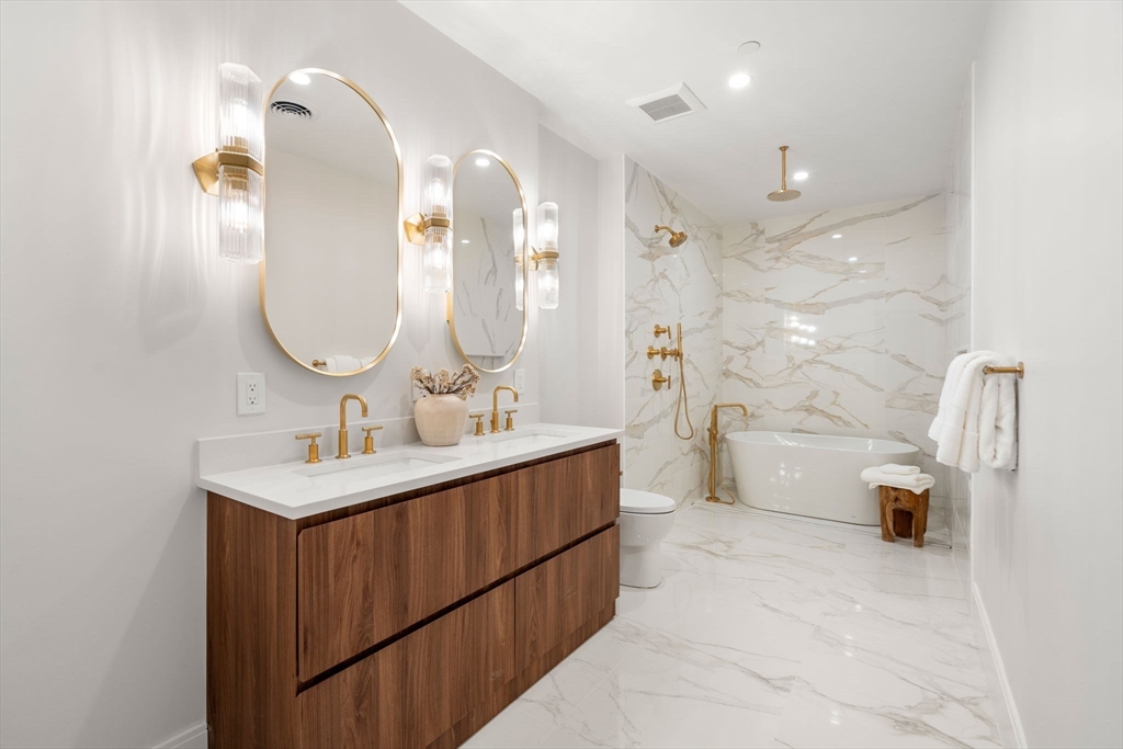 67 Church Street, Unit 1 Boston, MA 02116 - Photo 10 of 15 a bathroom with a double vanity sink mirror and shower