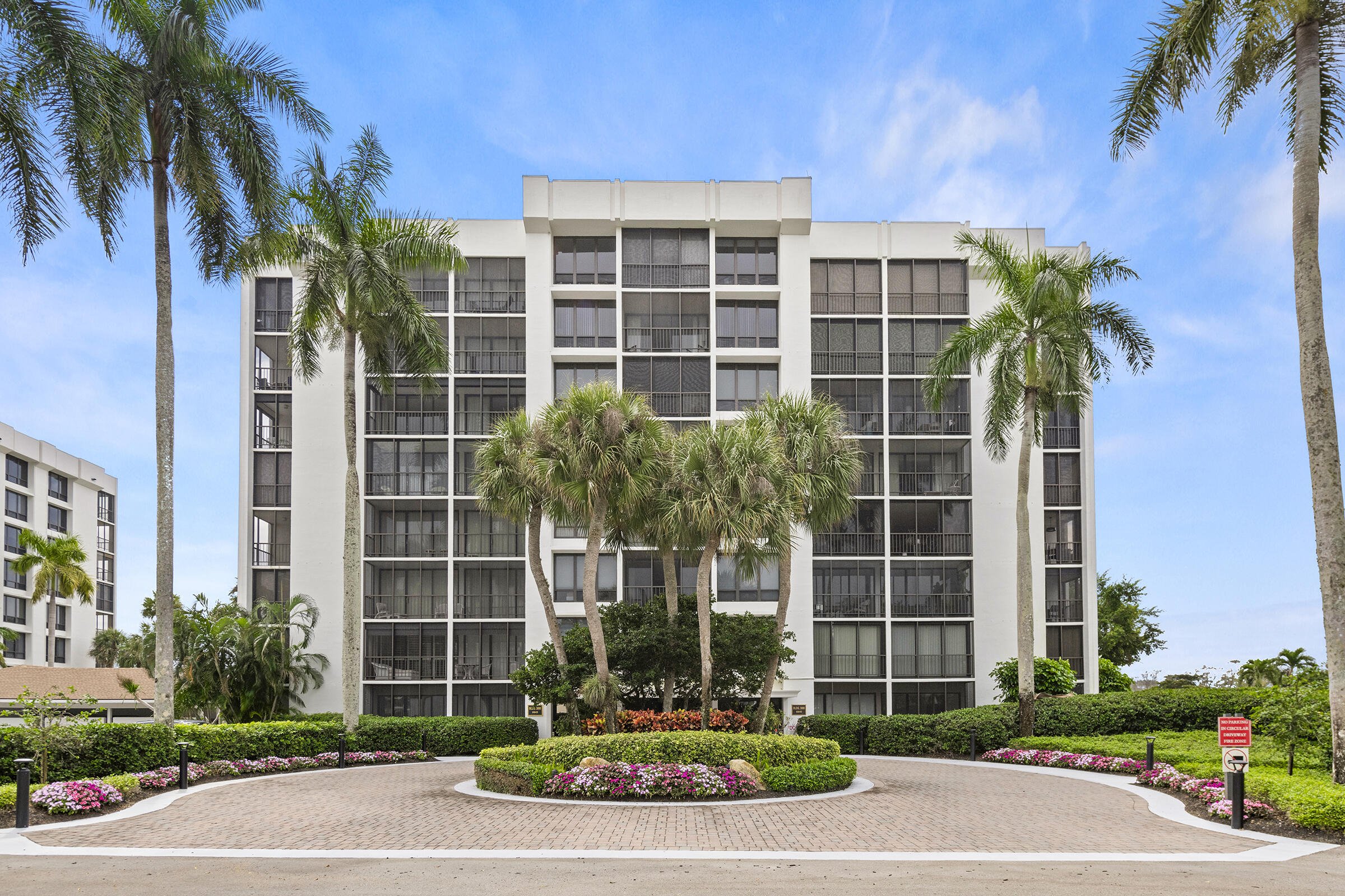6845 Willow Wood Drive, Unit 3012 Boca Raton, FL 33434 - Photo 1 of 28 a front view of a building with a garden