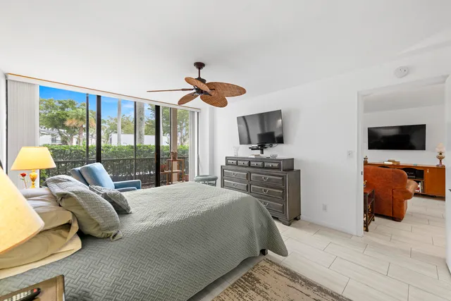 a bedroom with a bed and ceiling fan