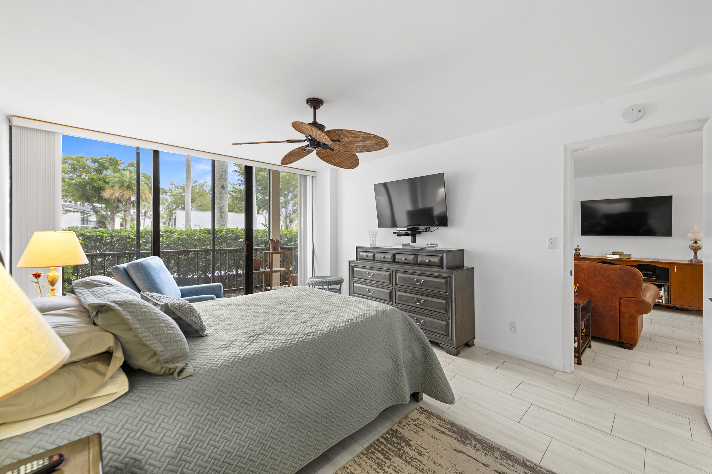 6845 Willow Wood Drive, Unit 3012 Boca Raton, FL 33434 - Photo 11 of 28 a bedroom with a bed and flat tv screen