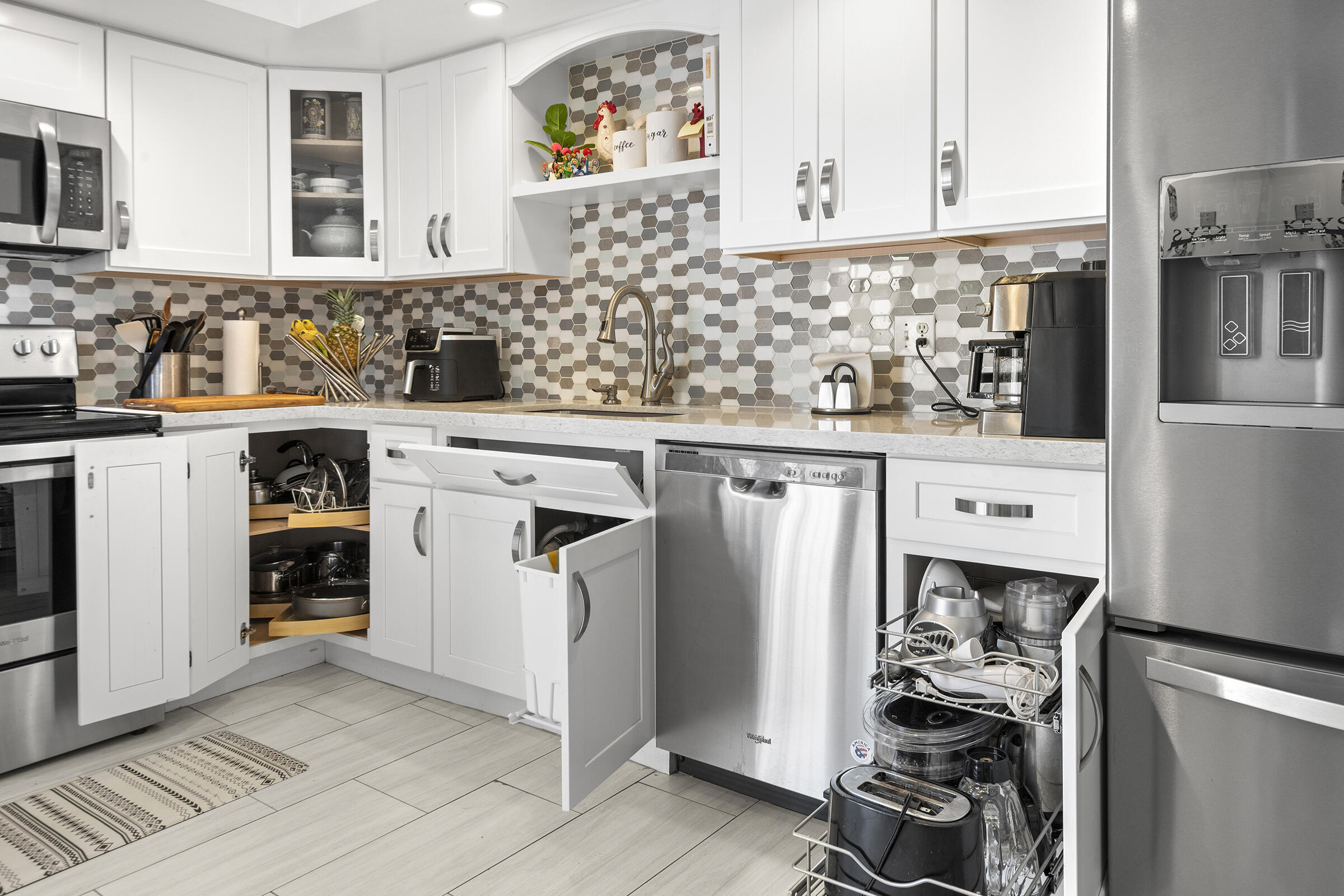 6845 Willow Wood Drive, Unit 3012 Boca Raton, FL 33434 - Photo 16 of 28 a kitchen with stainless steel appliances granite countertop a refrigerator and a sink
