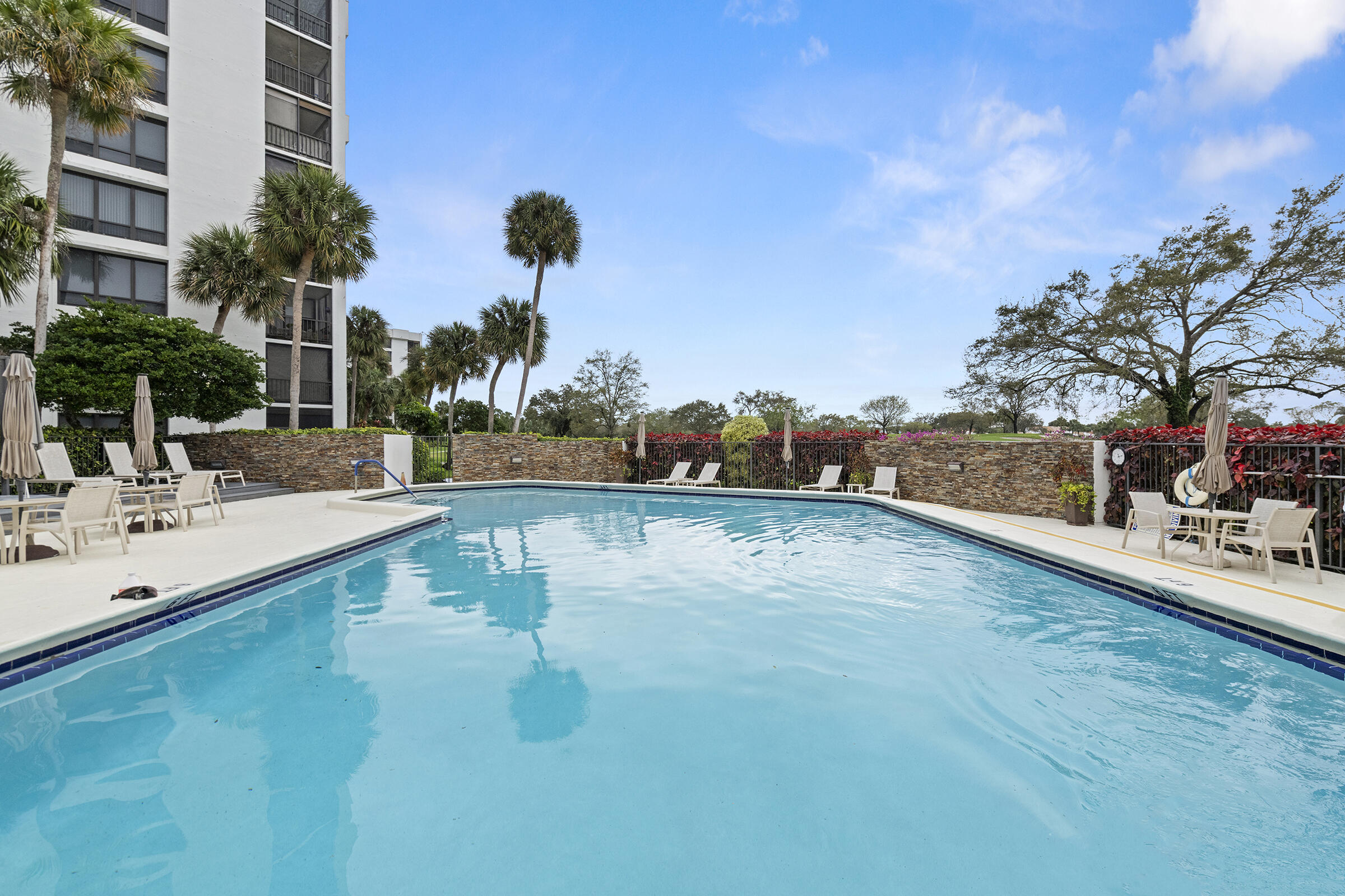 6845 Willow Wood Drive, Unit 3012 Boca Raton, FL 33434 - Photo 27 of 28 a view of a swimming pool with a yard