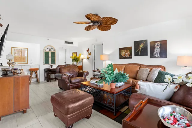 a living room with furniture potted plant and a window