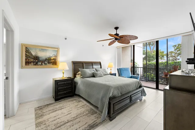 a bedroom with a bed and flat tv screen