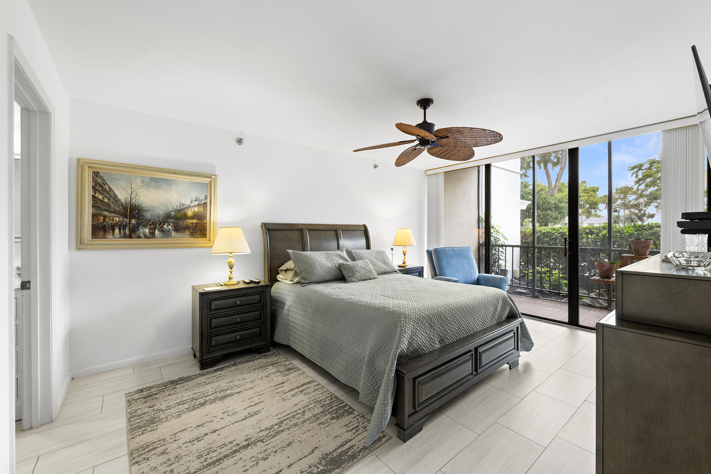 6845 Willow Wood Drive, Unit 3012 Boca Raton, FL 33434 - Photo 10 of 28 a bedroom with a large bed and a chandelier