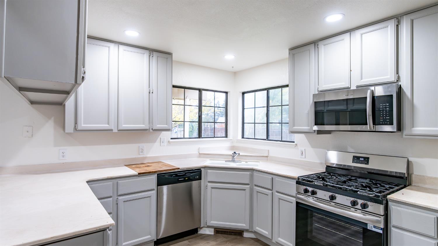 12501 Riverside Road Waterford, CA 95386 - Photo 11 of 24 a kitchen with stainless steel appliances a sink stove and cabinets
