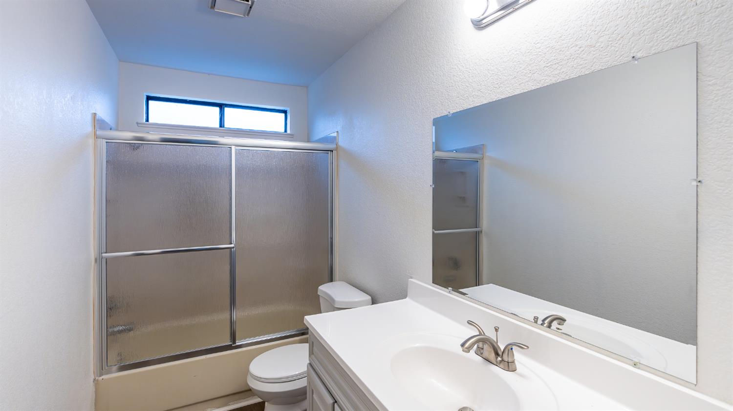 12501 Riverside Road Waterford, CA 95386 - Photo 12 of 24 a bathroom with a sink toilet and shower