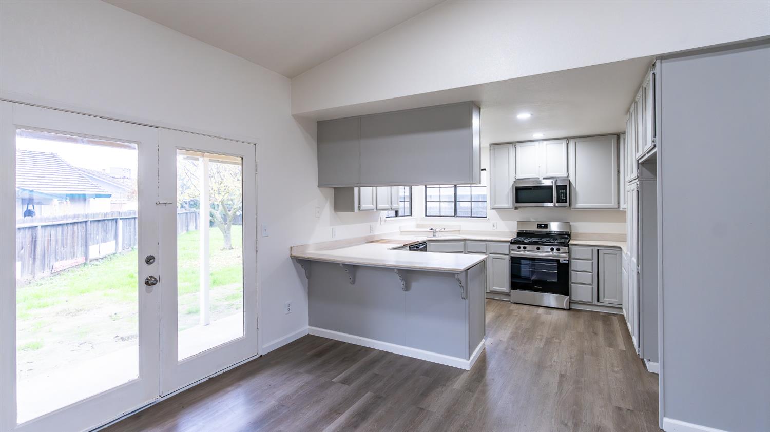 12501 Riverside Road Waterford, CA 95386 - Photo 8 of 24 a kitchen with stainless steel appliances granite countertop a stove a sink and a refrigerator