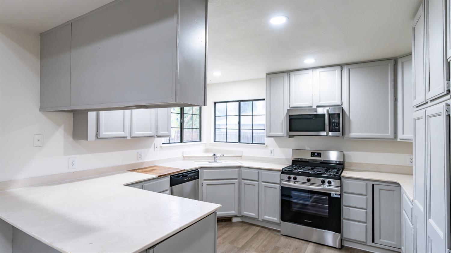 12501 Riverside Road Waterford, CA 95386 - Photo 9 of 24 a kitchen with stainless steel appliances a sink stove and microwave