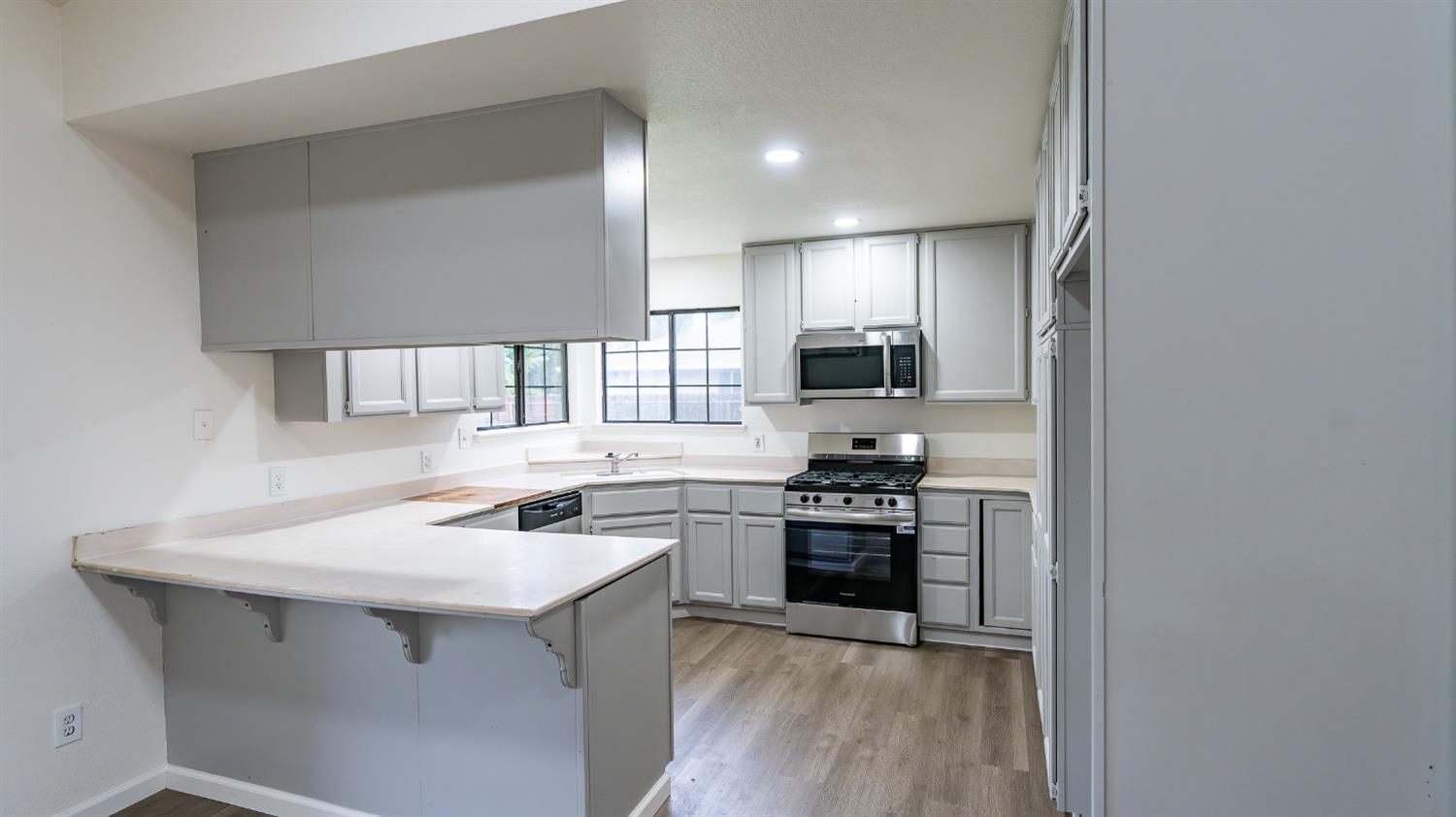 12501 Riverside Road Waterford, CA 95386 - Photo 10 of 24 a kitchen with a sink stove and refrigerator