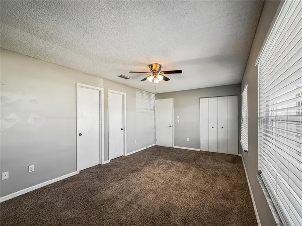 a view of a livingroom with a ceiling fan and window
