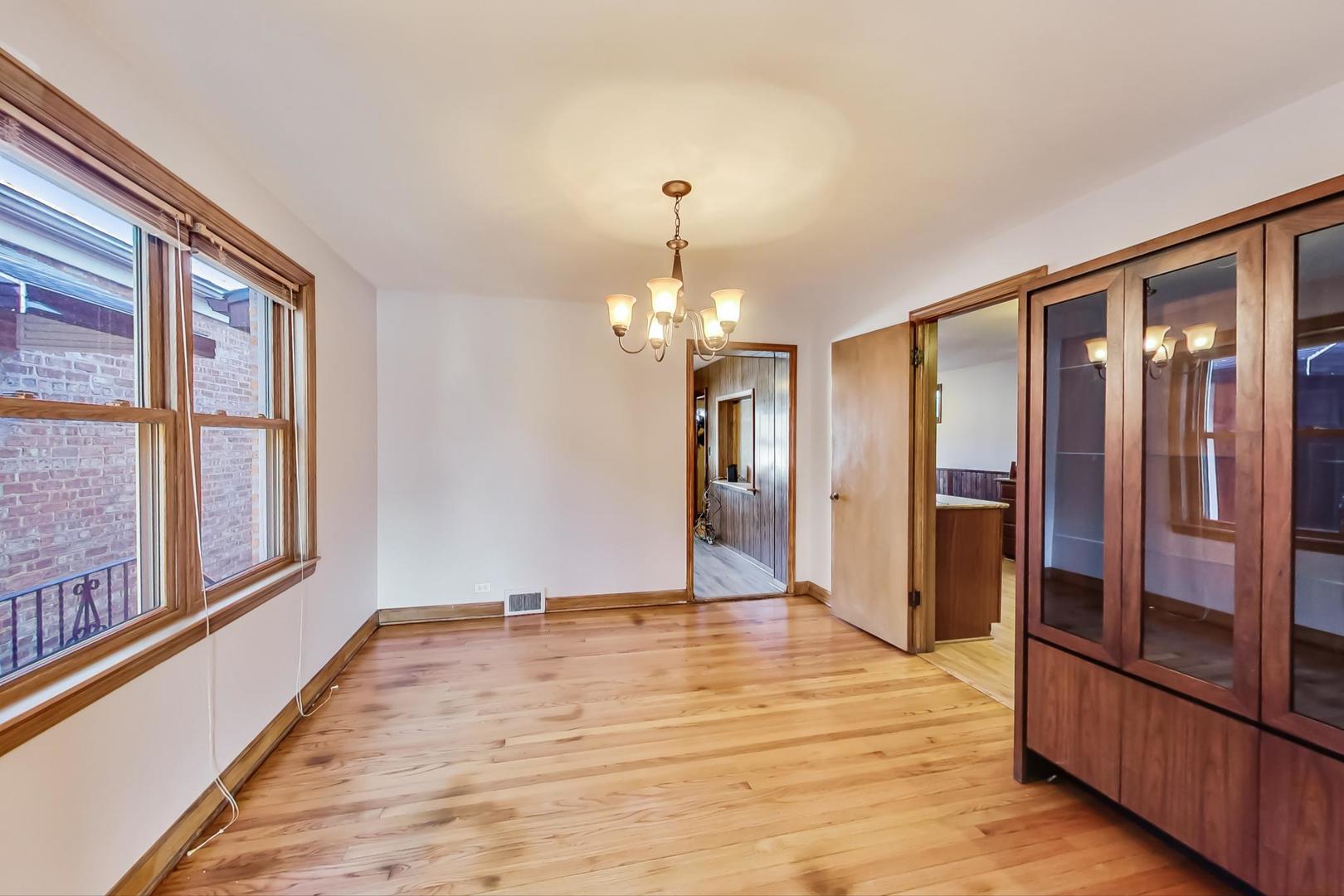 5231 North Rutherford Avenue Chicago, IL 60656 - Photo 7 of 43 a view of an empty room with window and wooden floor