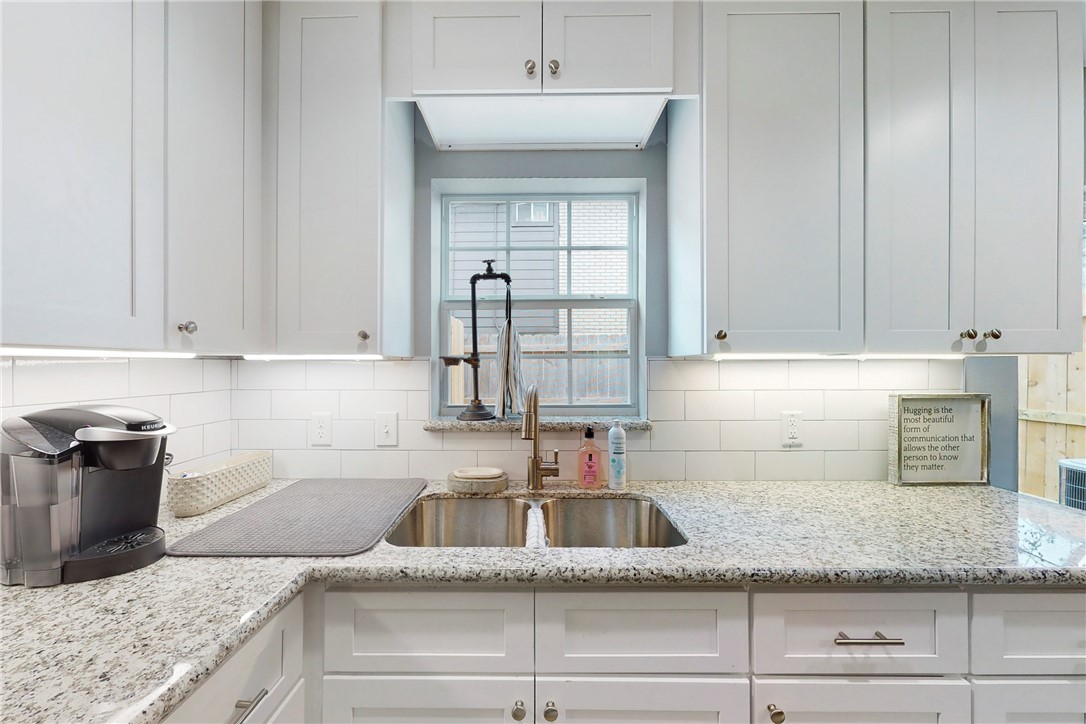 513 Boyett Street, Unit 2 College Station, TX 77840 - Photo 8 of 22 a kitchen with granite countertop a sink dishwasher stove and cabinets