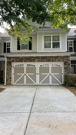 a view of a house with a yard and a garage