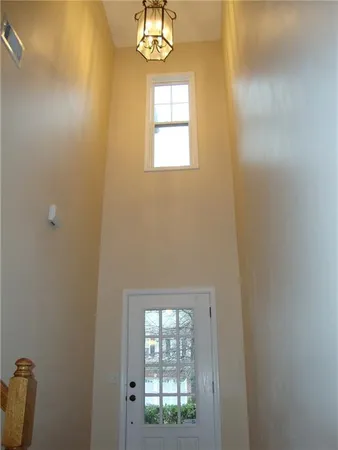 a view of a room with window a ceiling fan and wooden floor