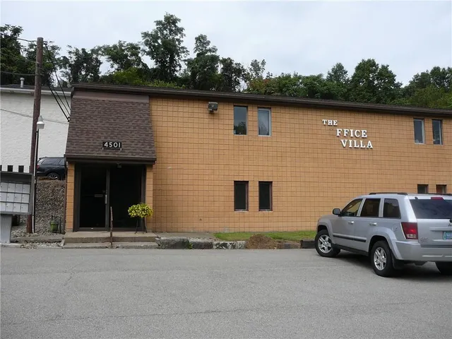 a view of a car park in front of house
